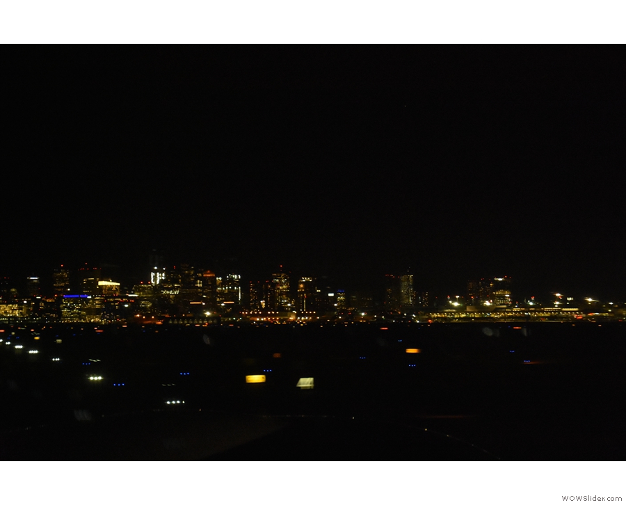 The airport runway lights, with downtown Boston visible across the harbour.