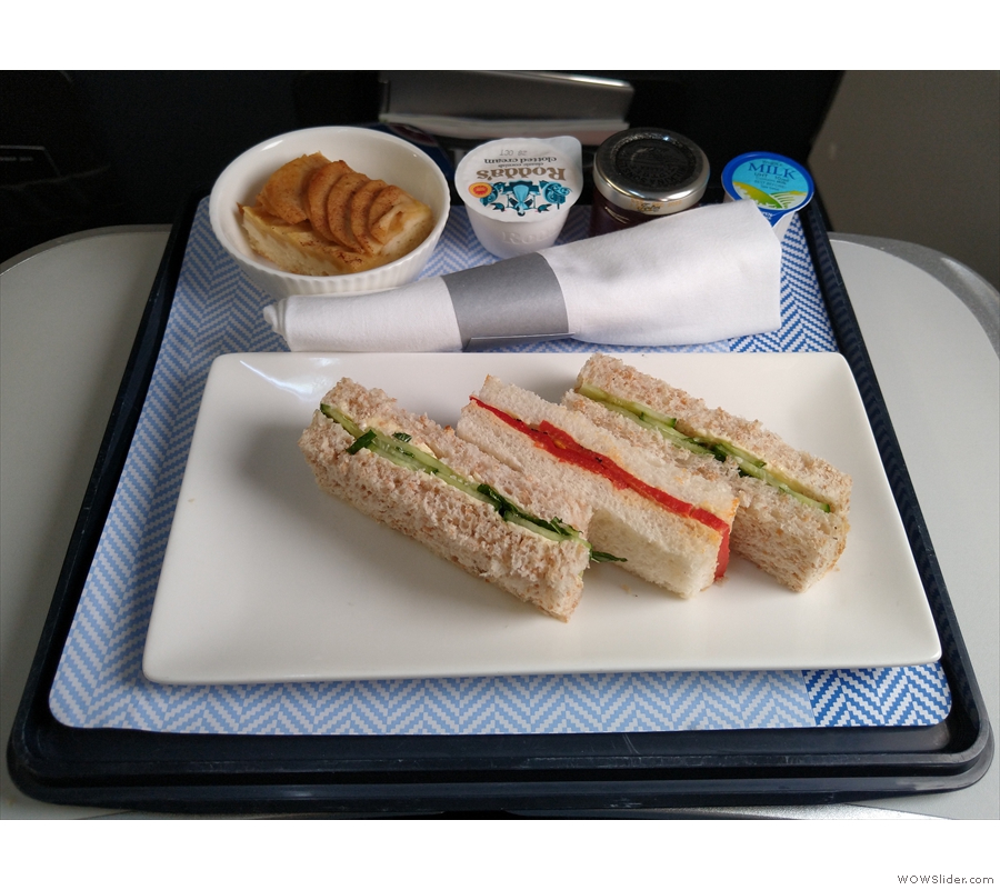 The seat-belt signs were still on, but the cabin crew were out serving afternoon tea.