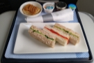 The seat-belt signs were still on, but the cabin crew were out serving afternoon tea.