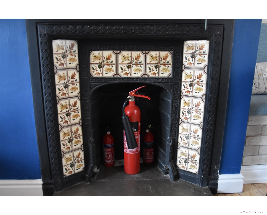 There are lots of lovely features in Fika⁺, including this wonderfully tiled fireplace.