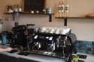 The coffee side of the operation is at the back of the counter, against the wall.