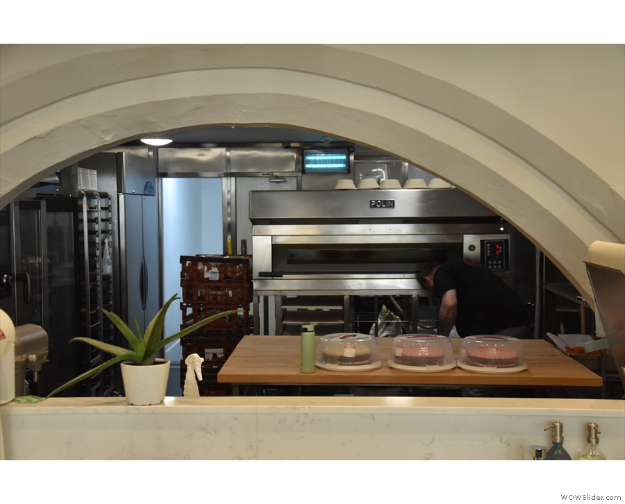 ... with the ovens of the bakery visible through a low arch at the back.