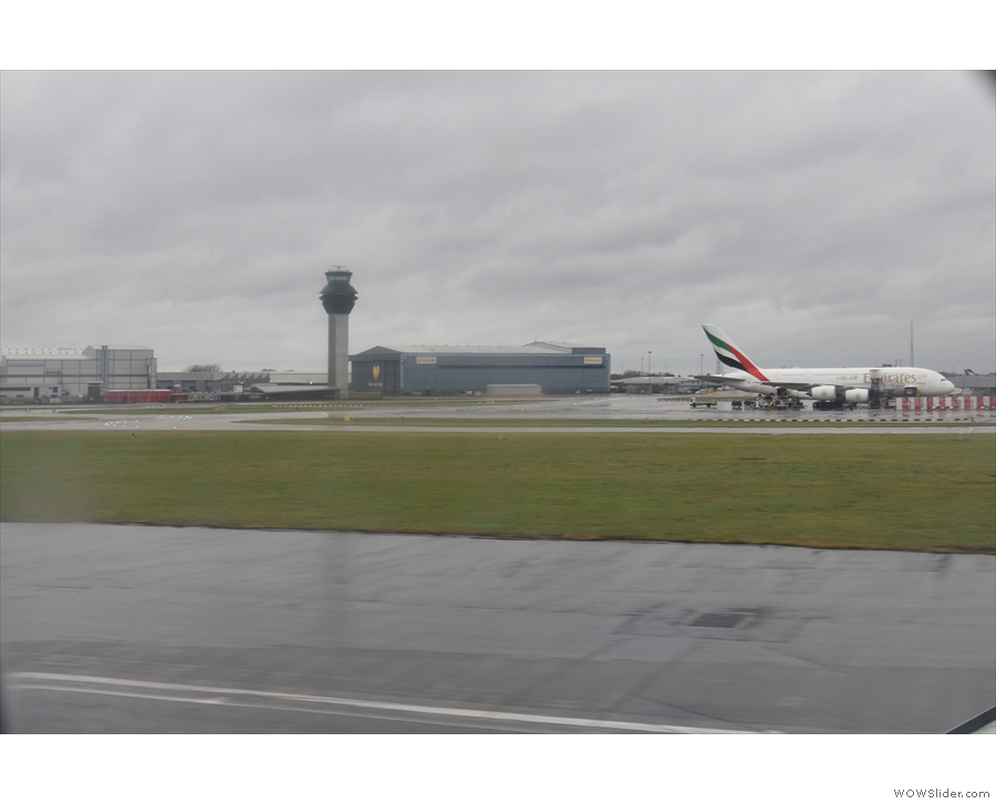 ... before continuing along the runway past Terminal 2 and the control tower...
