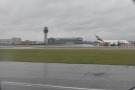 ... before continuing along the runway past Terminal 2 and the control tower...