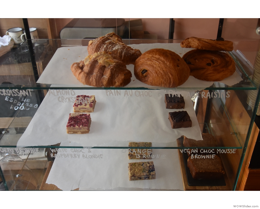 There's a selection of cakes and pastries in the glass display case...