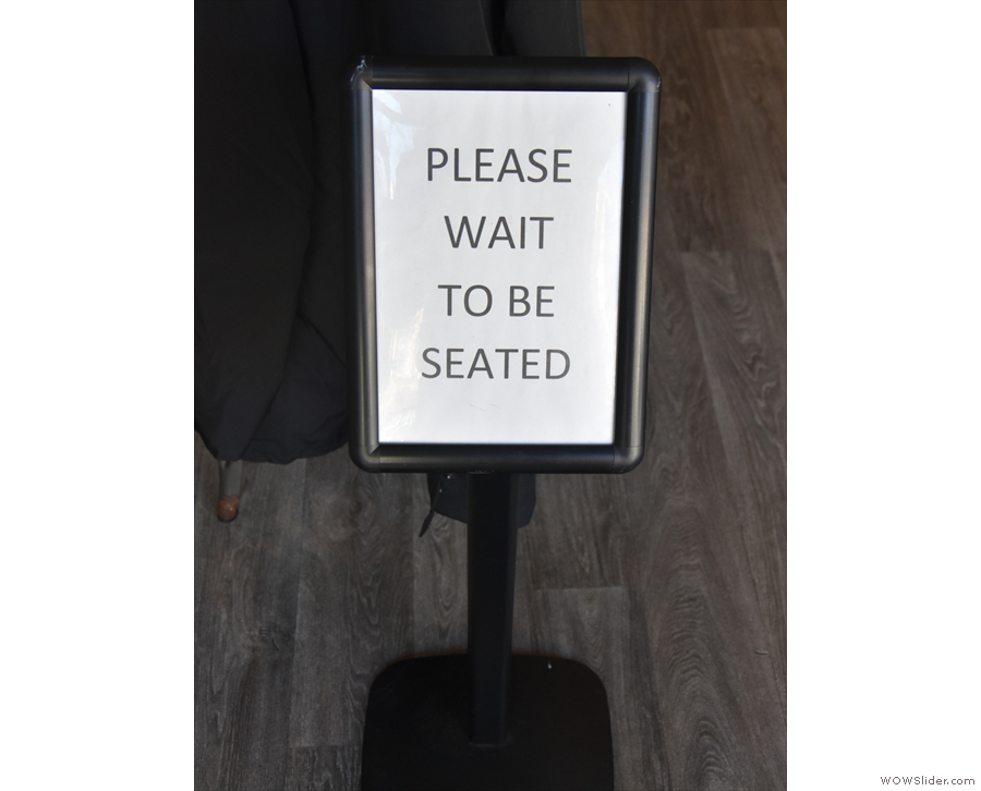 A polite notice greets you as you step inside (Haus offers full table service).