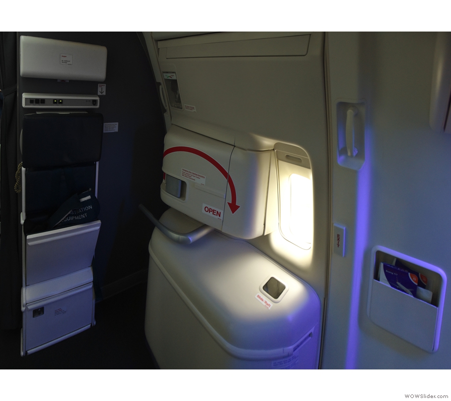 It's an exit row, so here's the emergency exit, along with a jump seat for the cabin crew.