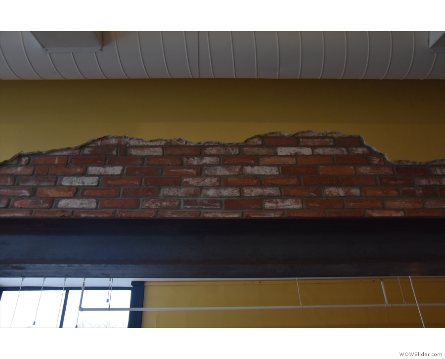 Other neat touches include the exposed brick above the supporting joist...