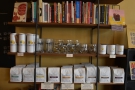 Coffee and books on display on the retail shelves opposite the counter.
