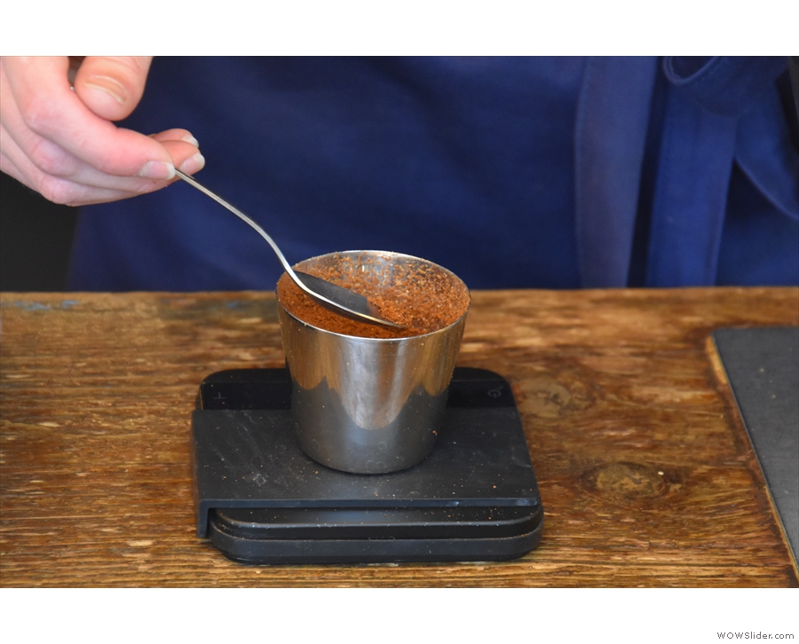 Impressive attention to detail: weighing the ground coffee to ensure the correct dose.