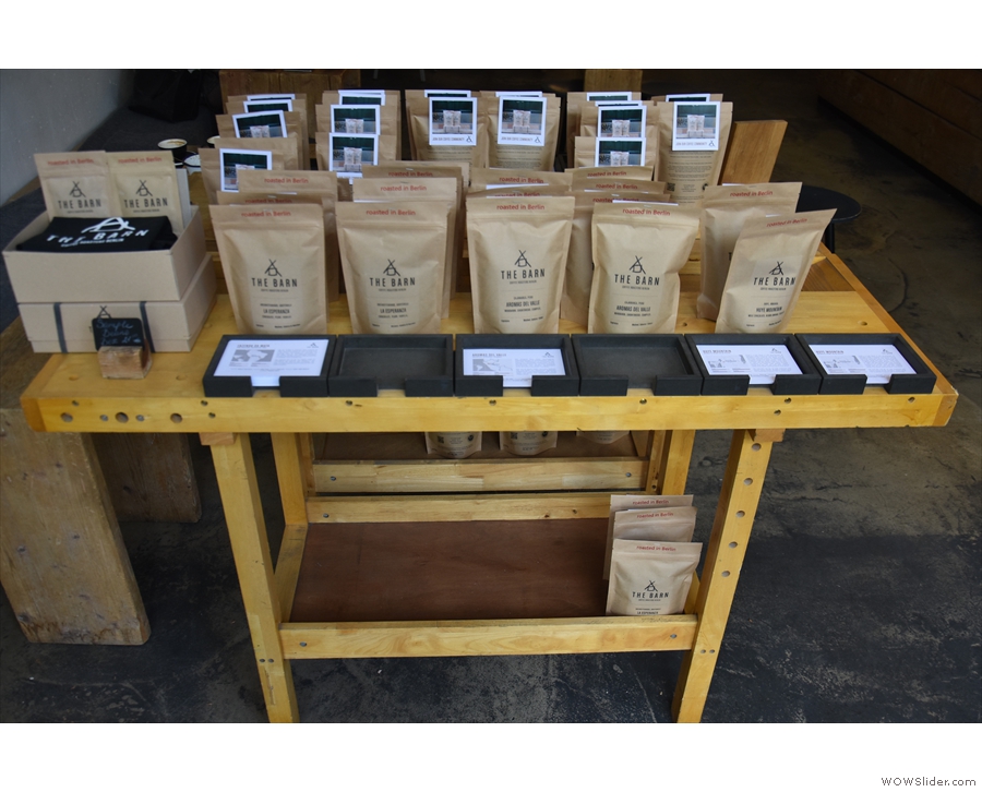 A table with retail bags of coffee greets you as you enter, with espresso one on side...