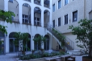 The courtyard is tall, surrounded on three sides by what I believe to be apartments.