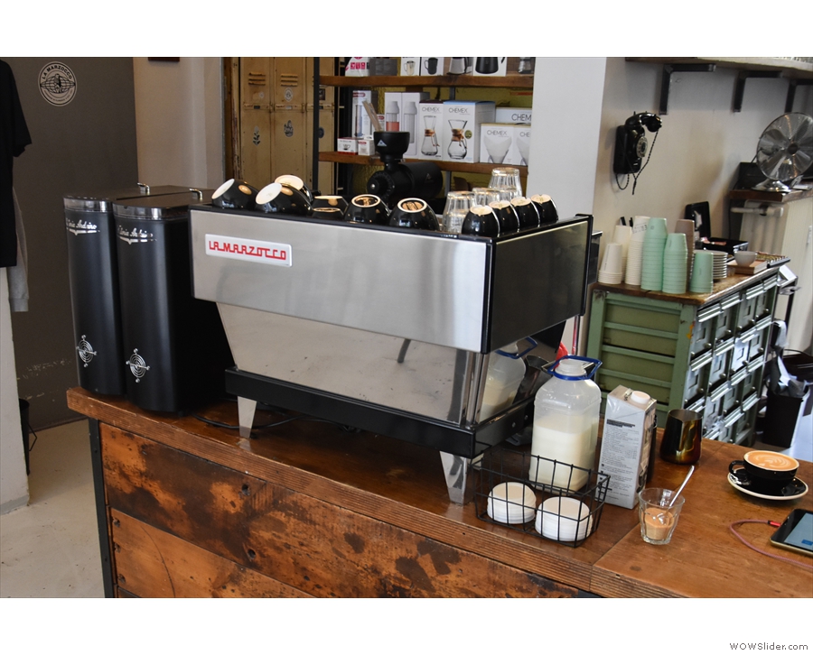 On the other end of the counter, you'll find the espresso machine and its grinders...