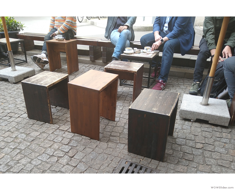 There's a plain, wooden table right in the middle of the space, but all the other tables...