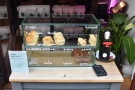 The day's selection of cakes are displayed in the glass case on the table.