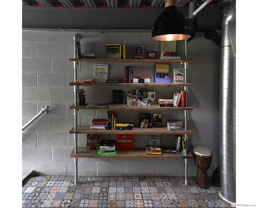 The shelves at the top of the stairs on the left hold a variety of music books.