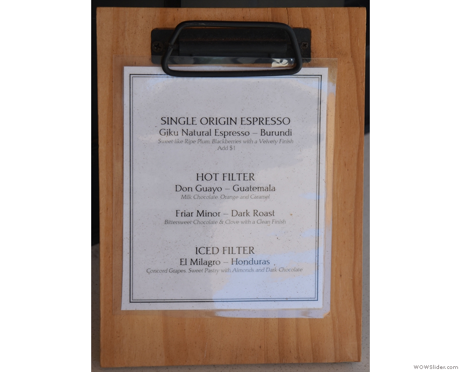 The single-origin espresso & batch brew filter choices are on a clipboard on the counter.