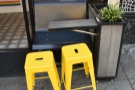 The outdoor seating is limited to two of these narrow tables, each with two stools...