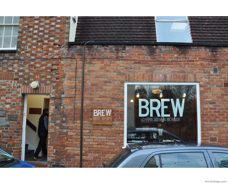 Brew, when you get there, is hard to miss with its big window sign. The door's on the left.