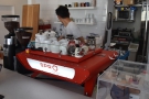 ... and beyond that, the bright red Kees van der Westen Spirit espresso machine.
