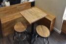 ... while the only other seating is this smaller L-shaped bench and table to the right.
