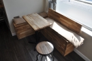 This L-shaped bench and table is to the right of the door, which is the only...