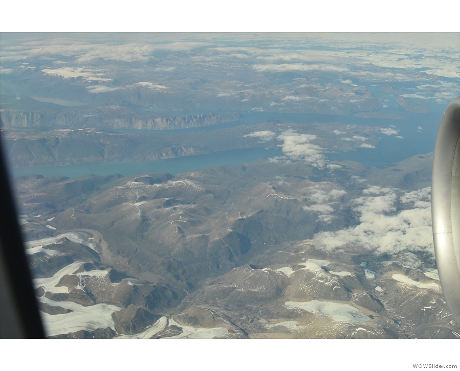 As we fly further inland, the landscape becomes more mountainous.
