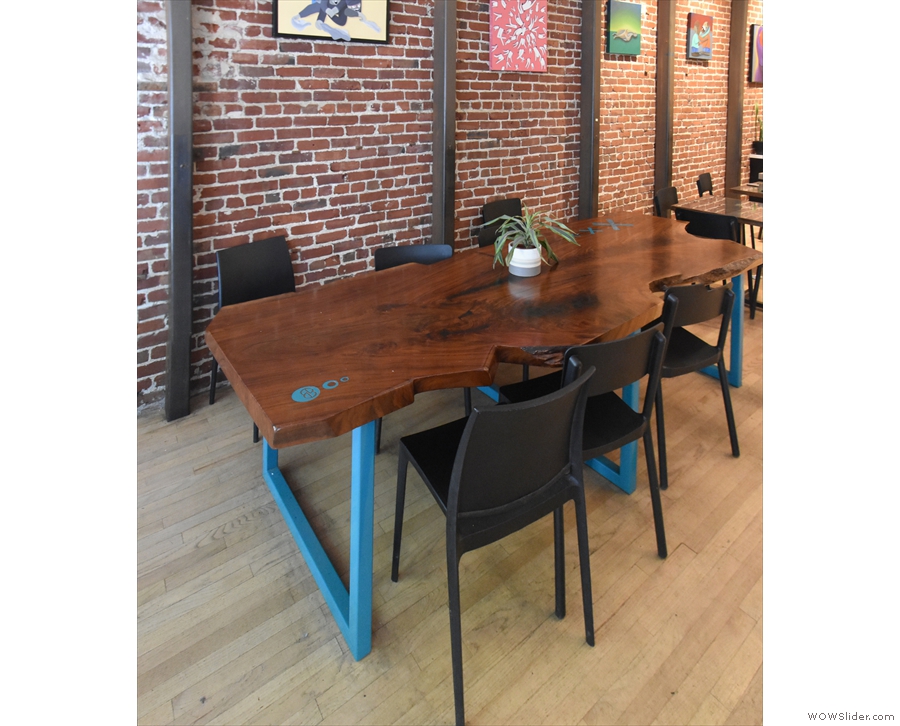 After window table to the left of the door comes this large, six-person communal table...