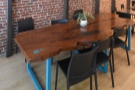 After window table to the left of the door comes this large, six-person communal table...