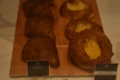 There are also some pastries on the countertop next to the display case.