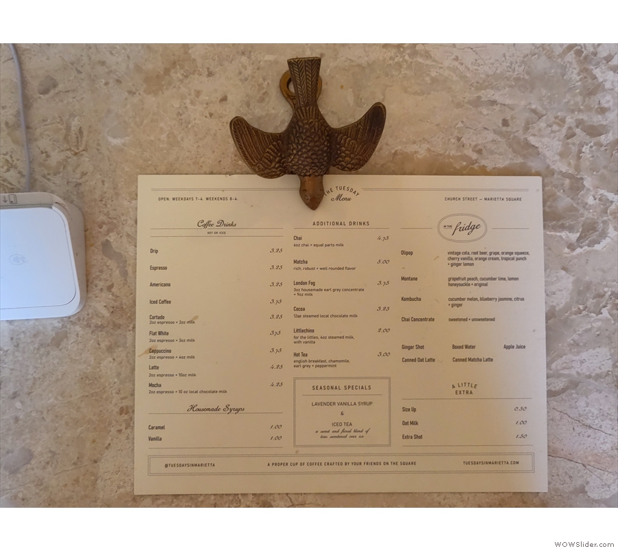 Last, but not least, the menu is on the counter, held in place by a wooden bird.