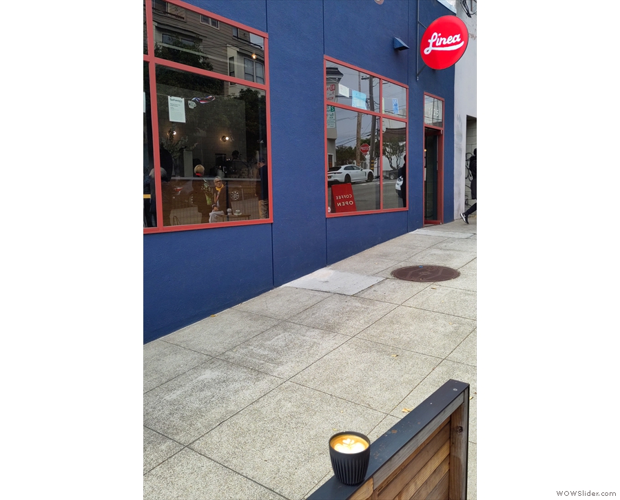 My coffee, checking out the front of Linea Coffee Roasting + Caffe.