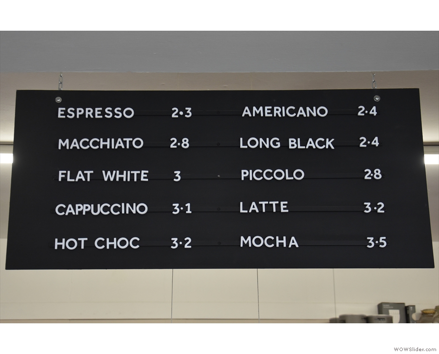 The concise menu hangs over the counter on two boards, one for coffee...