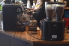 ... two-group Mirage espresso machine which sits on the corner with its three grinders.