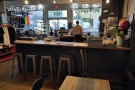 ... of Flat Track Coffee, starting with this row of four stools at the counter.