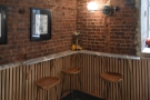 The interior seating consists of just three tall stools at this L-shaped bar to the right...