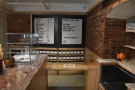 At the back, down the right-hand side of the counter, are a pair of doors which lead...