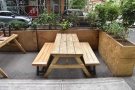 ... by waist-high wooden planters, which protect an outdoor seating terrace.
