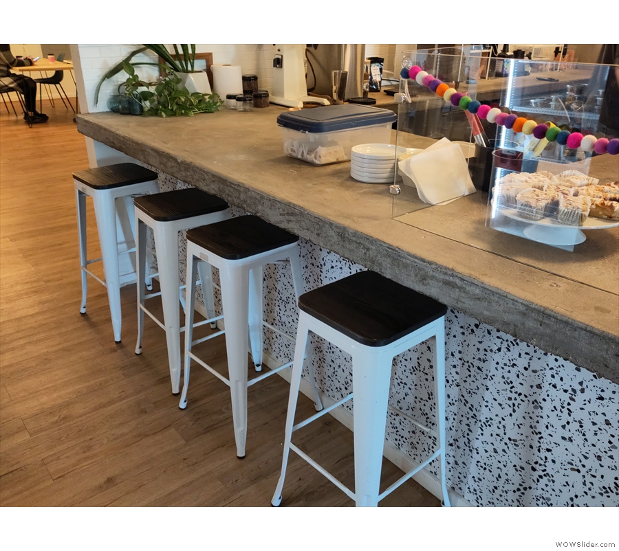 Back in the main room, there are also four stools at the end of the counter, while if you...