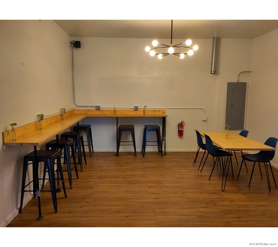 ... an L-shaped bar along the left-hand/back walls, with a four-person table in the corner.