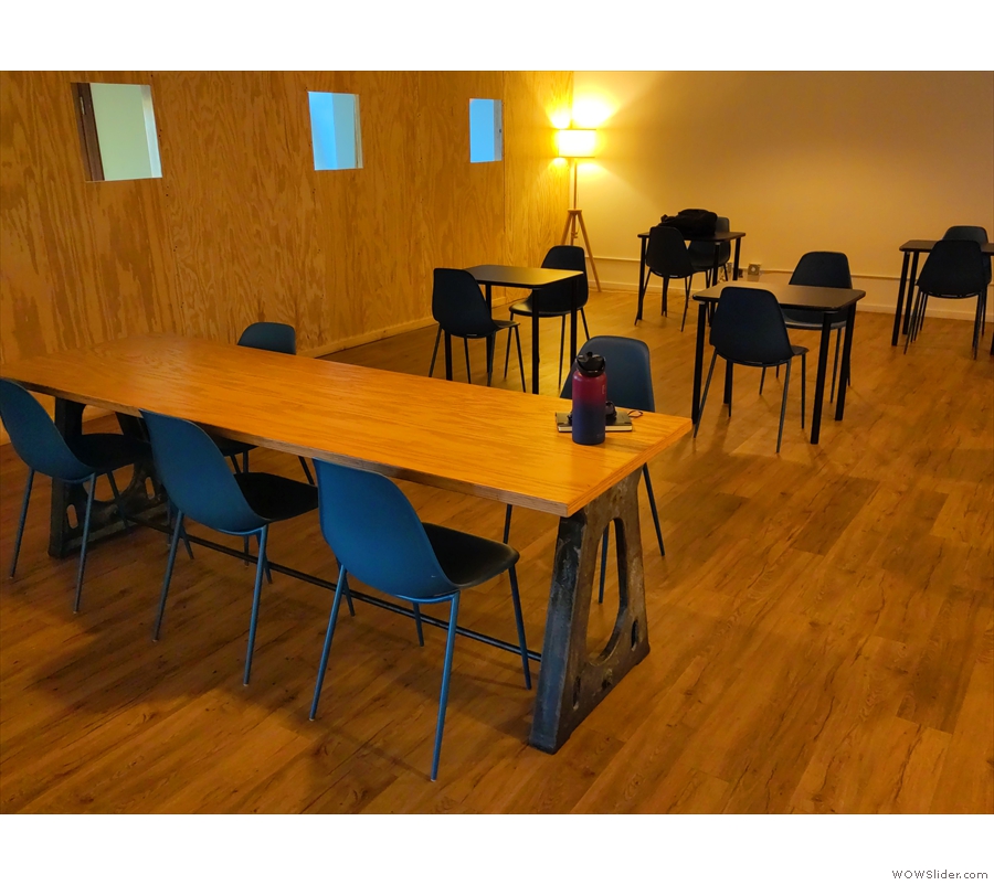 ... is a six-person communal table with a set of four tables beyond that.