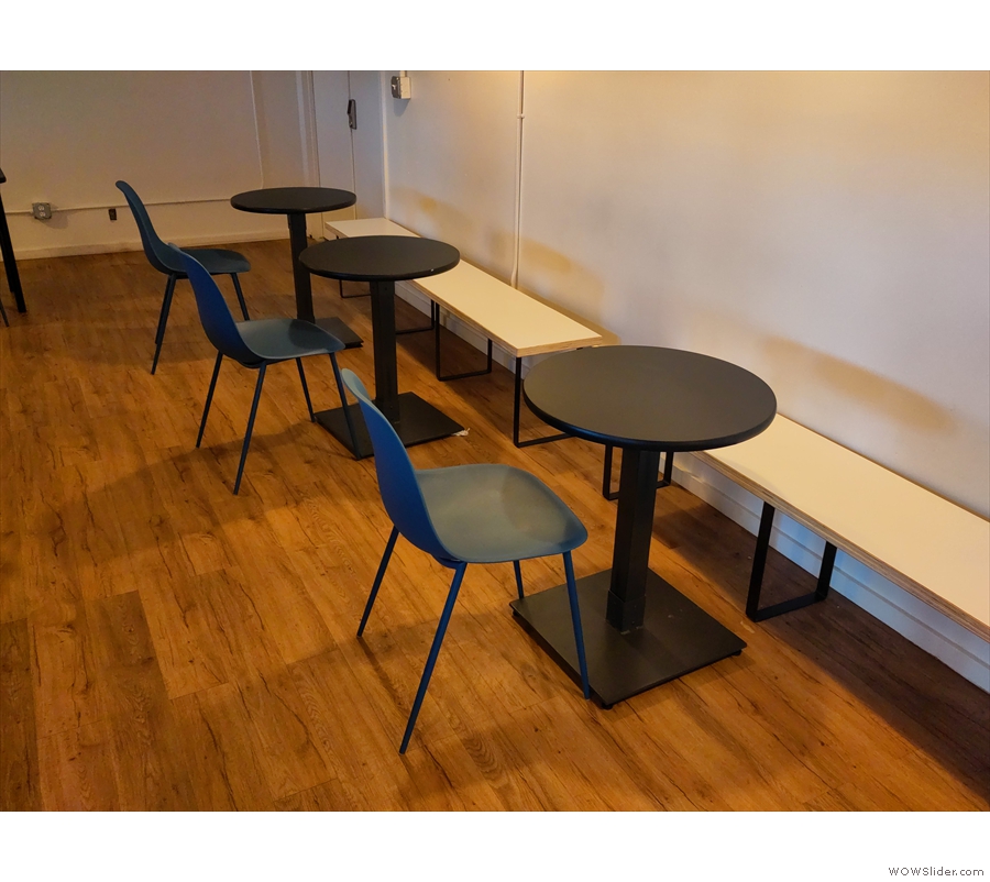 ... running along the back wall, along with three two-person tables, while in the middle...