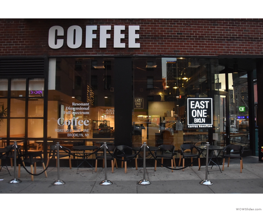 ... it's East One Coffee Roasters. There's a row of four tables outside on the busy...