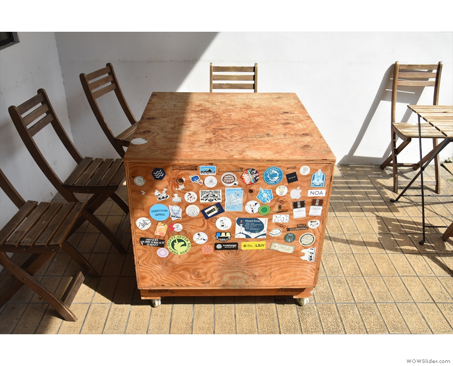 One of the tables is this packing case, which is decorated with stickers from...