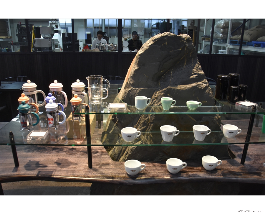 At one end is a display area for coffee equipment (left) and cups (front)...