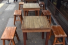 There are six two-person tables on the pavement, extendng to the left of Single O...