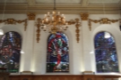 Three stained-glass windows soar above the alter.