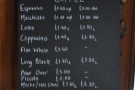 The coffee menu, chalked up by the door.