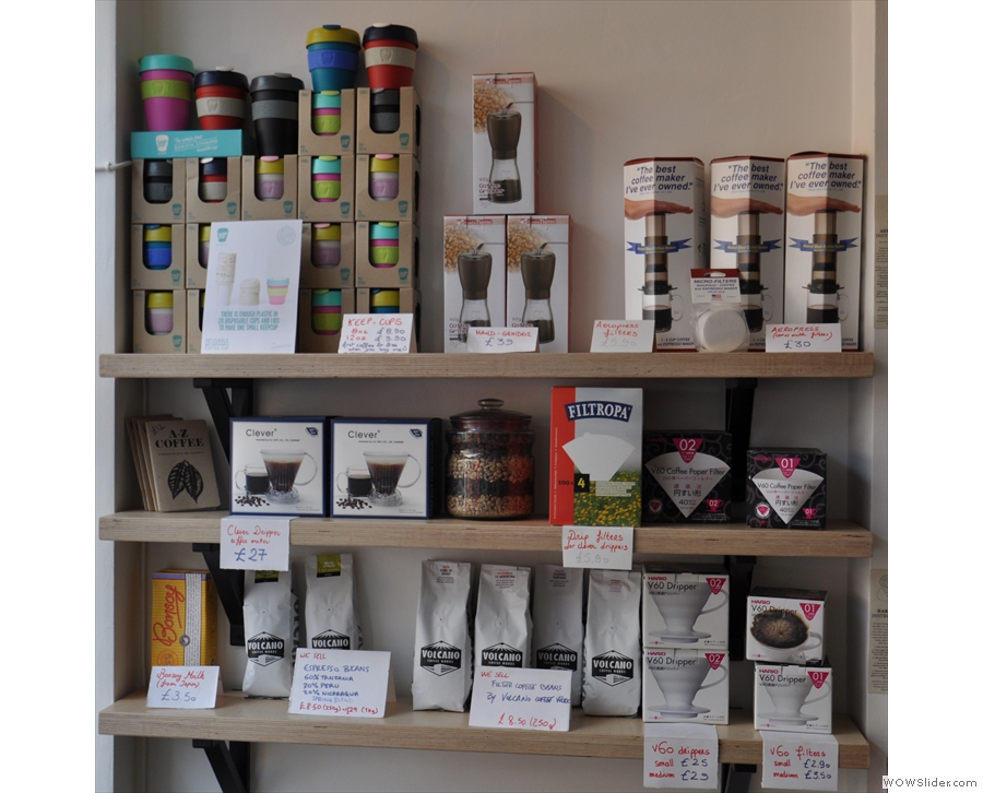 The opposite wall is given over to a shelf full of coffee beans and kit for sale.