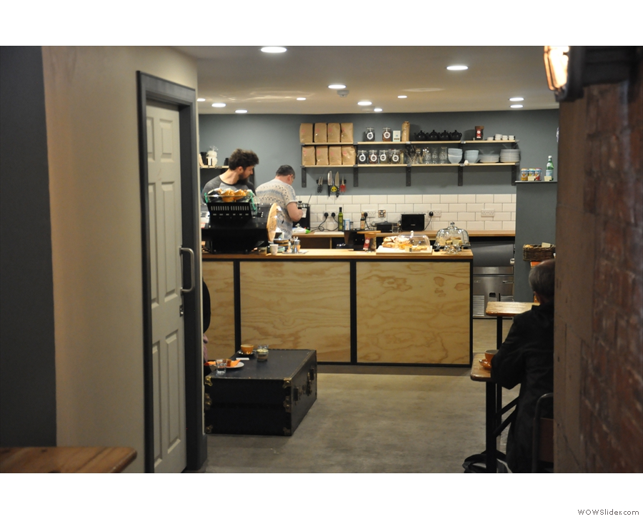 The space at the end of Cult Espresso: sofa (hidden on left), tables (right), counter (back).